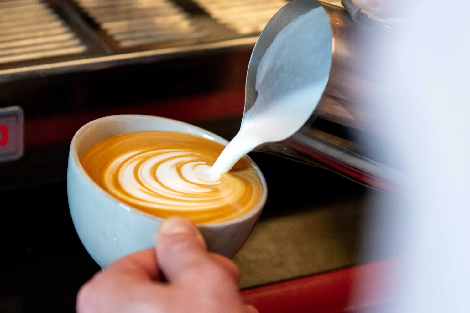 barista pouring coffee